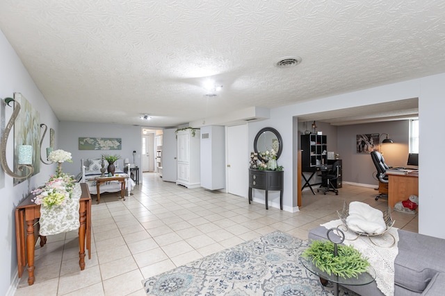 living room with a textured ceiling and light tile patterned floors