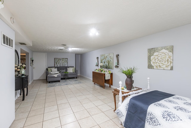 tiled bedroom with a textured ceiling