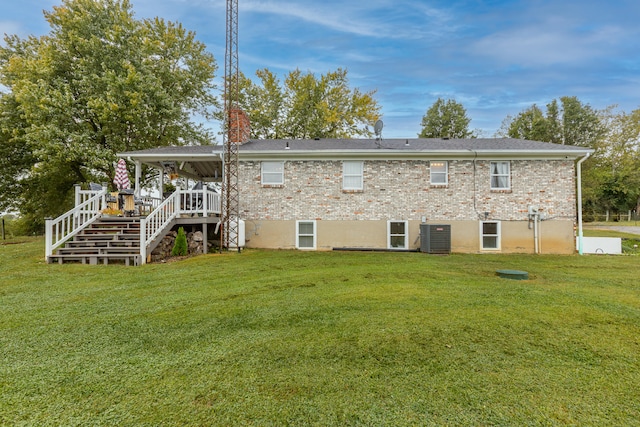 back of house featuring a lawn and central AC unit