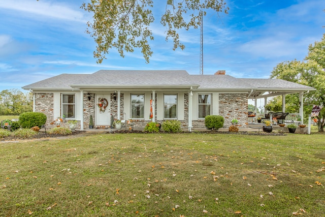 ranch-style home featuring a front lawn and a patio area