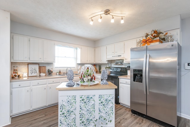 kitchen featuring stainless steel refrigerator with ice dispenser, white cabinetry, hardwood / wood-style floors, and electric range