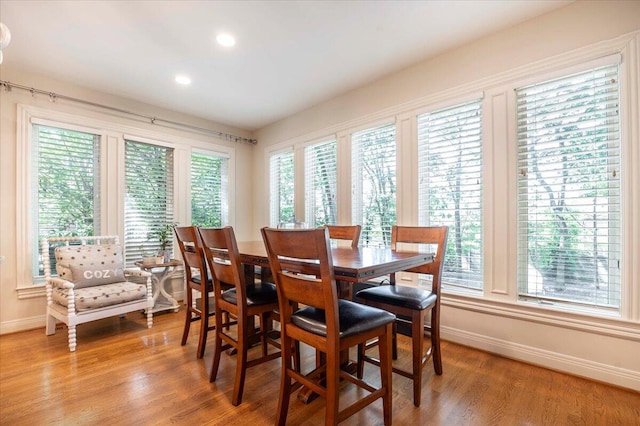 dining space with wood-type flooring