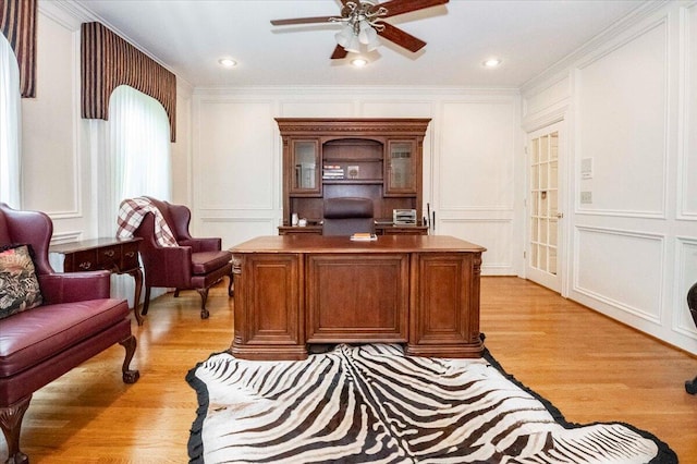 office space with ornamental molding, ceiling fan, and light hardwood / wood-style flooring