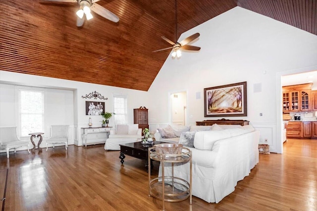 living room featuring high vaulted ceiling, ceiling fan, and hardwood / wood-style floors