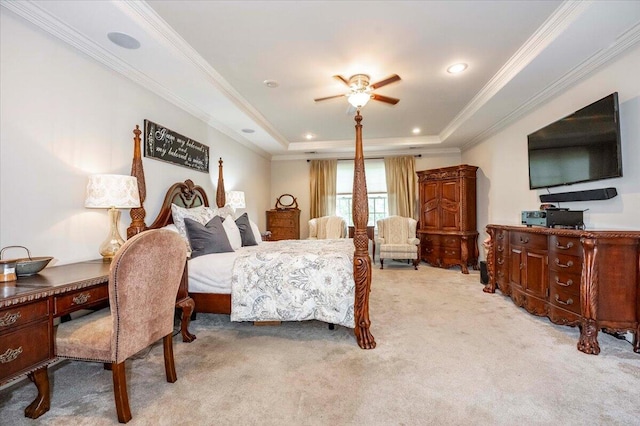 carpeted bedroom with ceiling fan, a raised ceiling, and crown molding