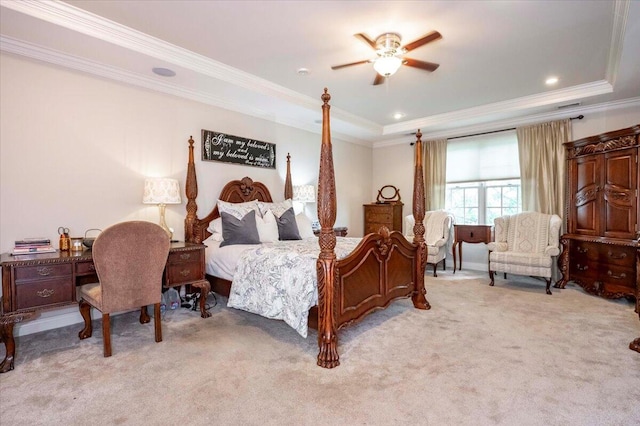 bedroom with ceiling fan, light colored carpet, a raised ceiling, and ornamental molding