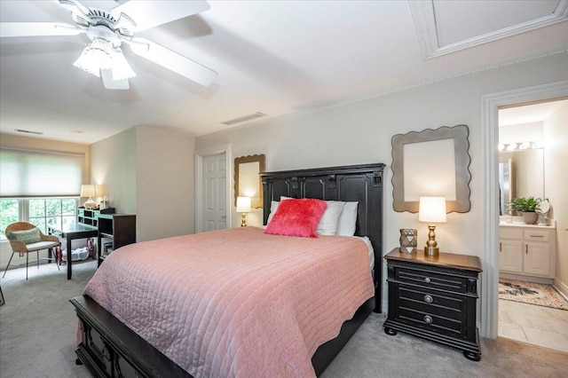 carpeted bedroom featuring ensuite bath and ceiling fan