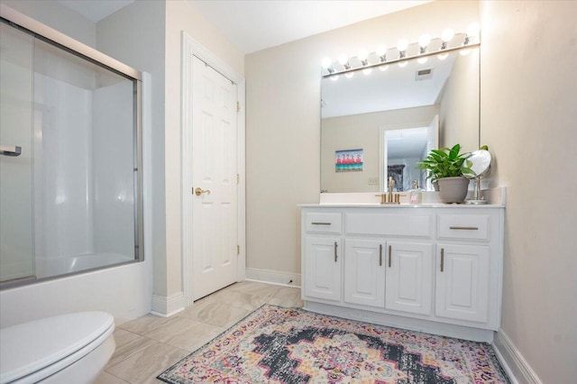 full bathroom featuring enclosed tub / shower combo, vanity, and toilet