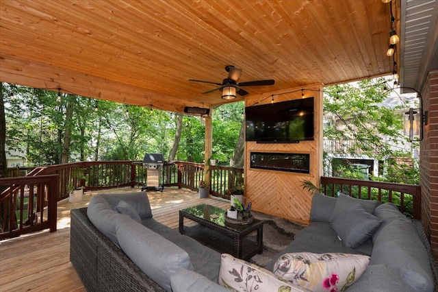 deck featuring a grill, ceiling fan, and outdoor lounge area