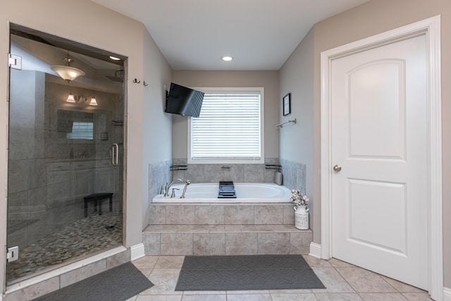 bathroom featuring tile patterned flooring and separate shower and tub