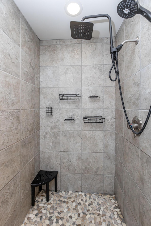 bathroom with tiled shower