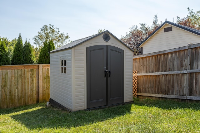 view of outbuilding featuring a yard