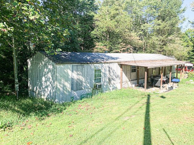 view of outbuilding featuring a yard