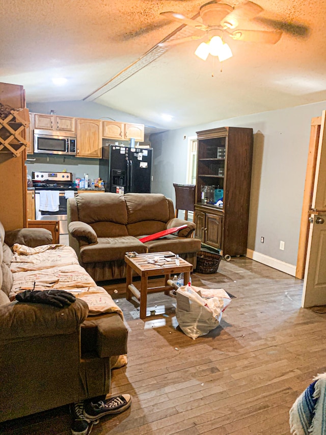 living room with light wood-type flooring, ceiling fan, and a textured ceiling