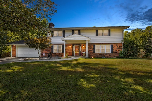 view of front of house with a yard and a garage