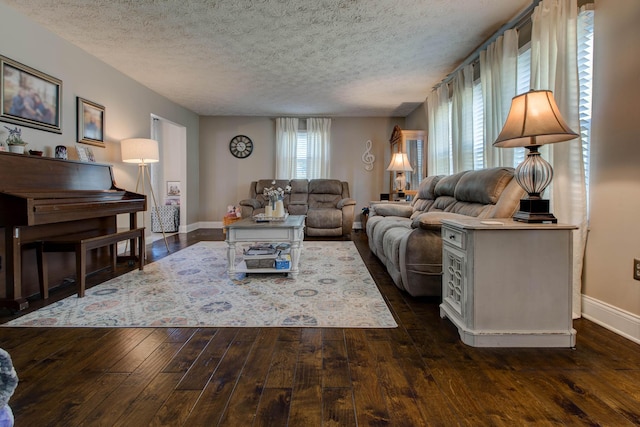 living room with a textured ceiling and dark hardwood / wood-style floors