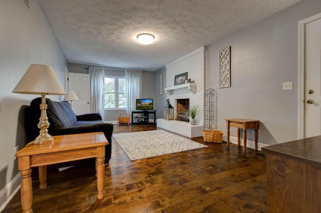 living room featuring a fireplace, a textured ceiling, and hardwood / wood-style flooring