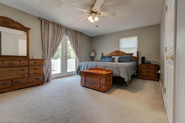 bedroom featuring ceiling fan, access to exterior, light carpet, and a textured ceiling