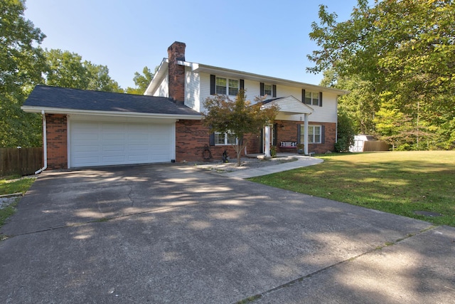 colonial home featuring a garage and a front yard