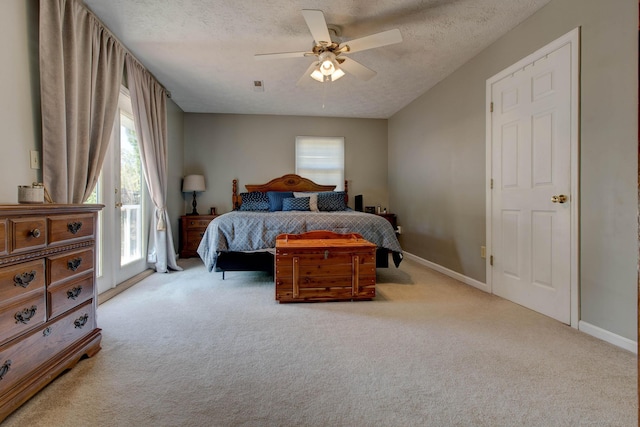 carpeted bedroom featuring a textured ceiling and ceiling fan