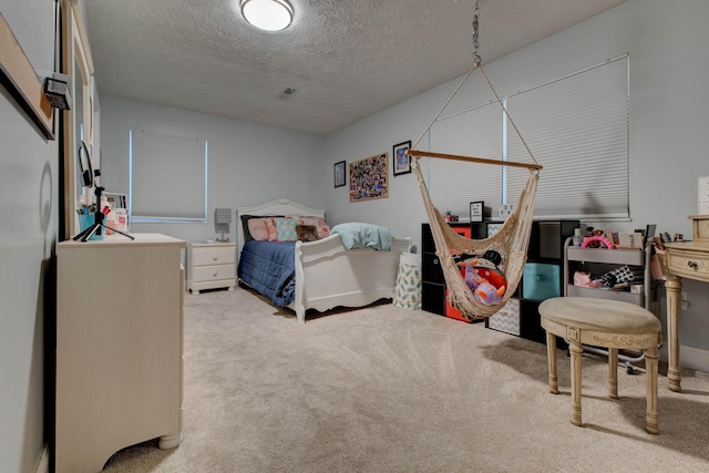 bedroom featuring a textured ceiling and carpet