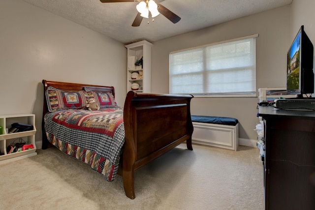 bedroom featuring a textured ceiling, ceiling fan, and carpet floors