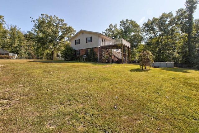 view of side of property featuring a yard and a wooden deck