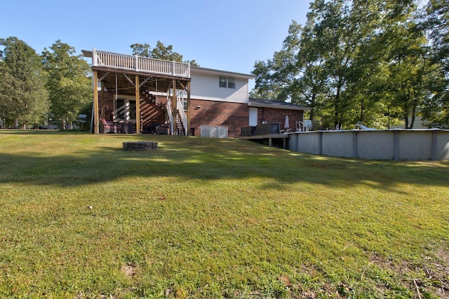 view of yard featuring a fire pit and a deck