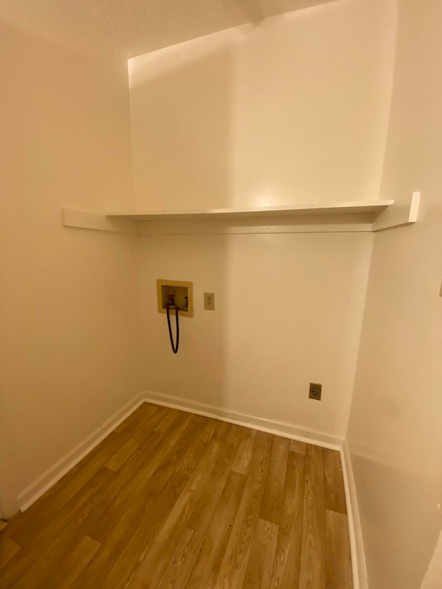 laundry room with hardwood / wood-style flooring and washer hookup