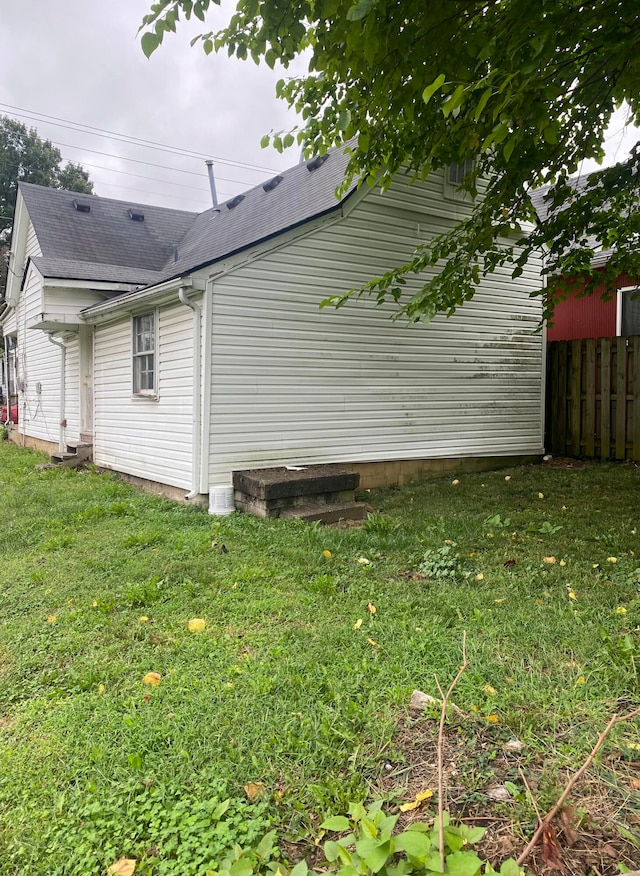 view of side of home with a lawn