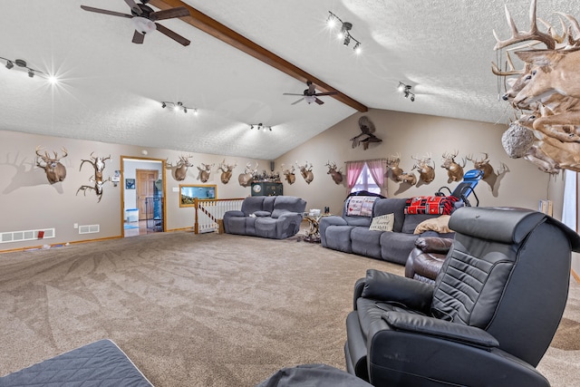 carpeted living room with lofted ceiling with beams, a textured ceiling, and ceiling fan