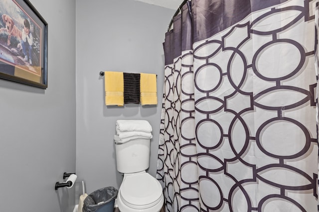 bathroom with toilet and curtained shower