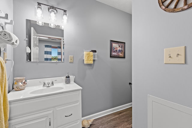 bathroom with a textured ceiling, vanity, and hardwood / wood-style flooring