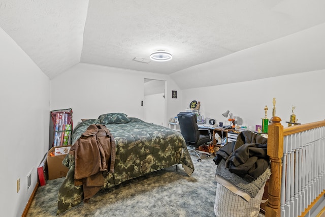 carpeted bedroom with lofted ceiling and a textured ceiling