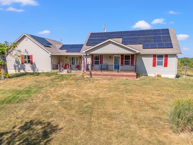 ranch-style house featuring a front lawn, solar panels, and a porch