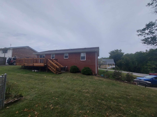 back of house featuring a deck and a yard