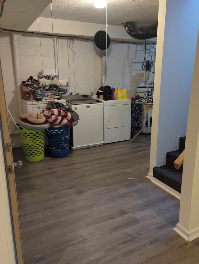 washroom with washing machine and clothes dryer, sink, and dark hardwood / wood-style floors