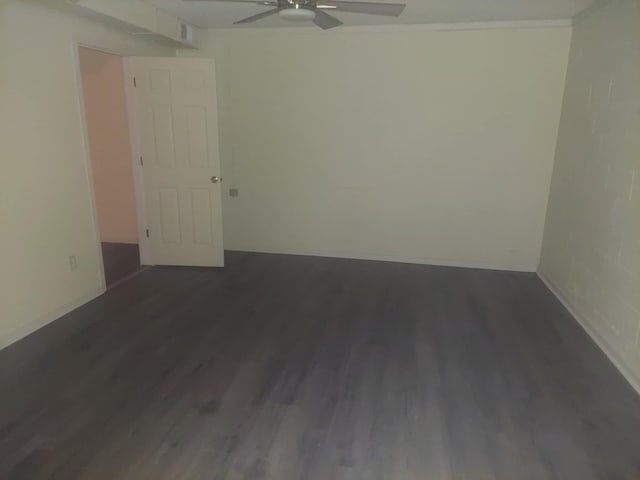 unfurnished room featuring ceiling fan, dark hardwood / wood-style flooring, and ornamental molding