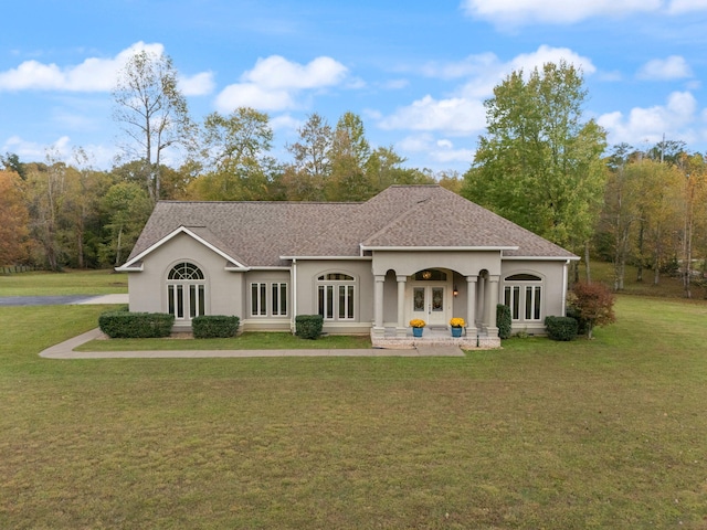 exterior space with stucco siding, french doors, and a front yard