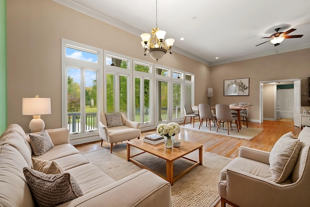 living room with crown molding, plenty of natural light, and light wood-type flooring