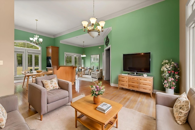 living room featuring ornamental molding, light hardwood / wood-style floors, and a chandelier