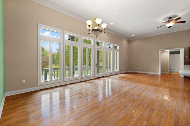 unfurnished living room with ornamental molding, ceiling fan with notable chandelier, and light wood-type flooring