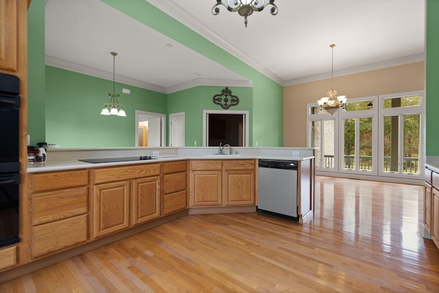 kitchen featuring dishwasher, sink, hanging light fixtures, and a notable chandelier