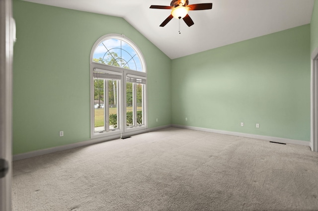 spare room featuring lofted ceiling, carpet floors, and ceiling fan