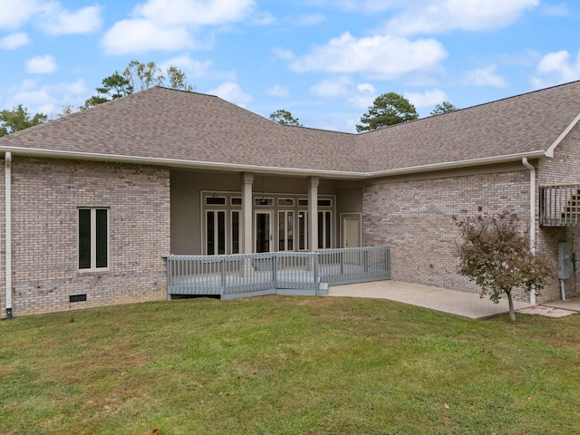 rear view of house with a yard and a patio area