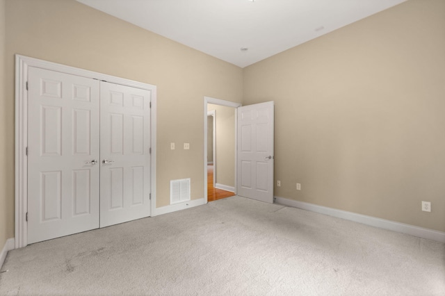 unfurnished bedroom featuring a closet and carpet