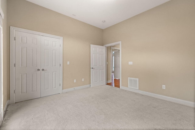 unfurnished bedroom featuring carpet floors and a closet