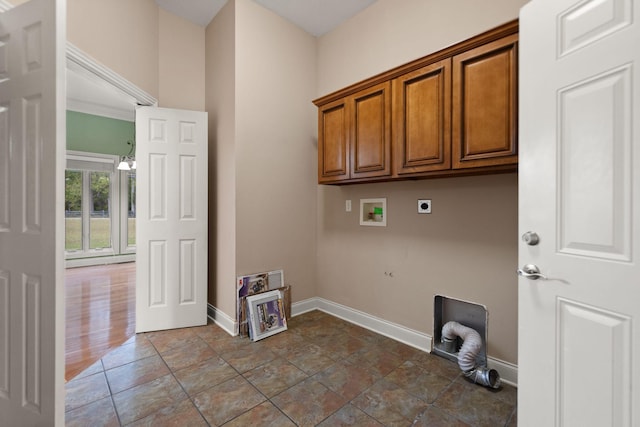 laundry area featuring electric dryer hookup, hookup for a washing machine, and cabinets