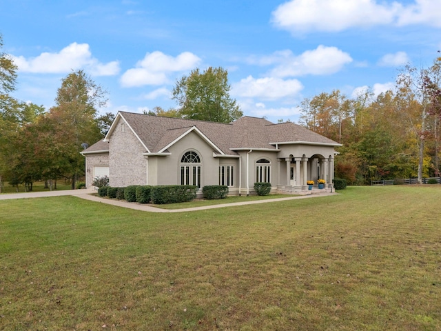 view of front of home with a garage and a front lawn