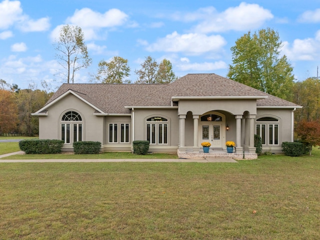 view of front of home with french doors and a front lawn